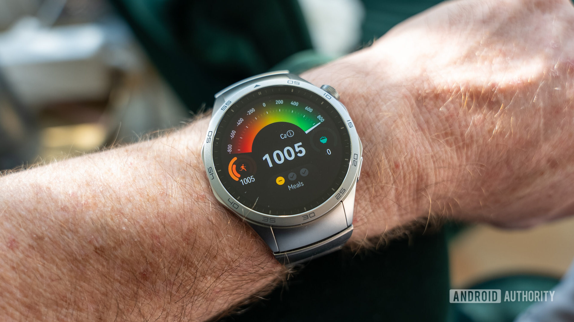 The Huawei Watch GT 4 smartwatch on the wrist shows the calorie count