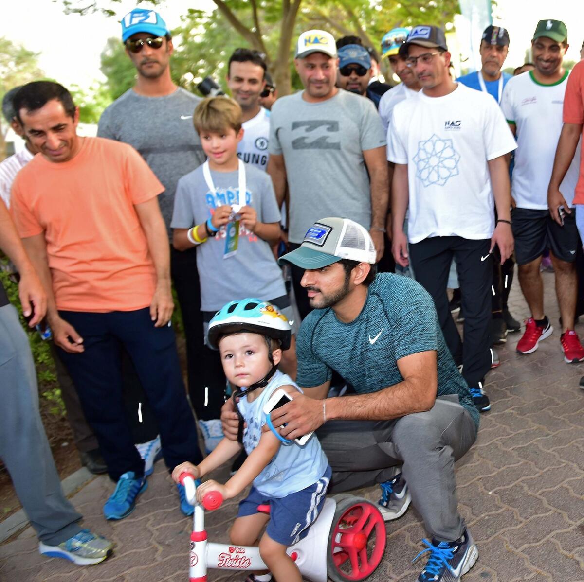 October 20, 2017: Sheikh Hamdan shares a sweet moment as he poses with a young man on the opening day of the Dubai Fitness Challenge at Safa Park. Image: KT File